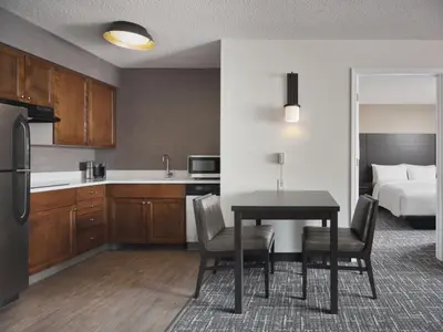 a kitchen and dining room with a table and a bed at Residence Inn by Marriott Albany East Greenbush/Tech Valley in East Greenbush