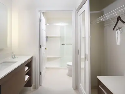 a white bathroom with a toilet and a sink at Residence Inn by Marriott Albany East Greenbush/Tech Valley in East Greenbush
