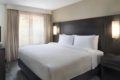 a large white bed in a room with a window at Residence Inn by Marriott Albany East Greenbush/Tech Valley in East Greenbush