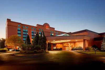 a large building with a driveway in front of it at Marriott Hartford/Windsor Airport in Windsor