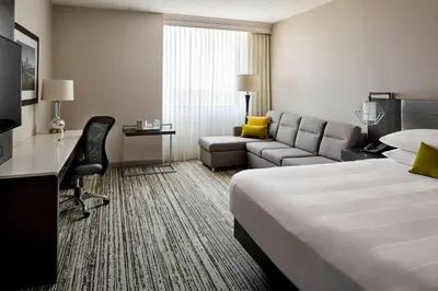 a hotel room with a bed and a couch at Marriott Hartford/Windsor Airport in Windsor