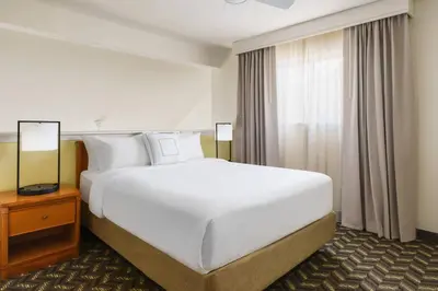 a large white bed in a hotel room with a window at Residence Inn by Marriott Hartford Windsor in Windsor