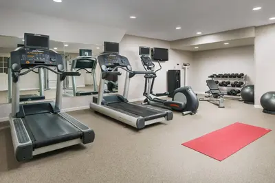 a gym with treadmills and ellipticals in a room at Residence Inn by Marriott Hartford Windsor in Windsor