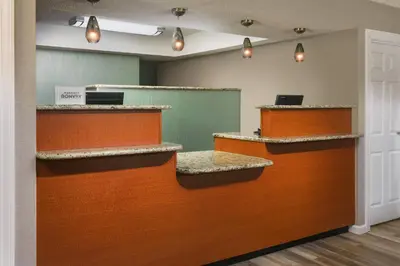 an empty waiting room with orange and brown counters at Residence Inn by Marriott Hartford Windsor in Windsor