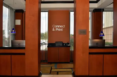 a lobby with a conference andrint sign on the wall at Fairfield Inn Hartford Airport in Windsor Locks