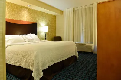 a hotel room with a large bed and a window at Fairfield Inn Hartford Airport in Windsor Locks