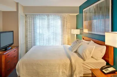 a bedroom with a large bed and a television at Residence Inn Hartford Avon in Avon