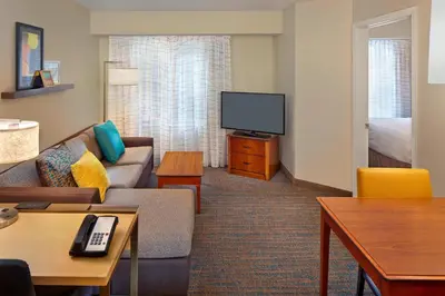 a living room with a couch and a flat screen tv at Residence Inn Hartford Avon in Avon