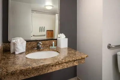 a bathroom with a sink and a mirror at Courtyard Hartford Cromwell in Cromwell
