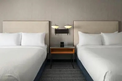 two beds sitting next to each other in a room at Courtyard Hartford Cromwell in Cromwell