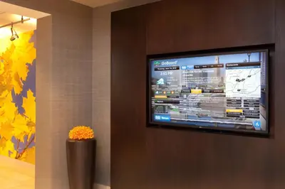 a flat screen tv on a wall in a room at Courtyard Hartford Manchester in Manchester