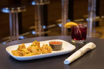 a plate of food on a table with a drink at Courtyard Hartford Manchester in Manchester
