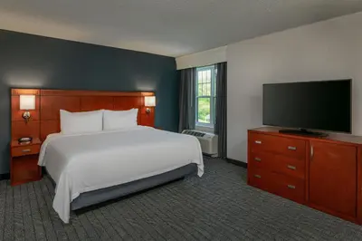 a bedroom with a bed and a flat screen tv at Courtyard Hadley Amherst in Hadley