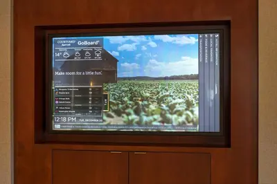 a television with a picture of a field of crops at Courtyard Hadley Amherst in Hadley