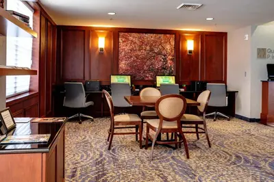 a conference room with a table and chairs at Courtyard Hadley Amherst in Hadley
