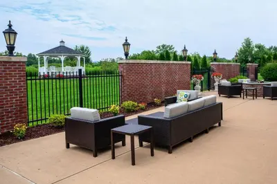 a patio with chairs and a gazebo and a fence at Courtyard Hadley Amherst in Hadley