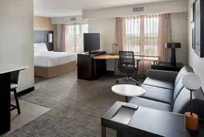a hotel room with a bed and a couch at Residence Inn Hartford Manchester in Manchester