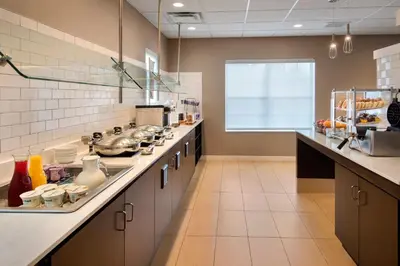 a large kitchen with a counter with many dishes at Residence Inn Hartford Manchester in Manchester