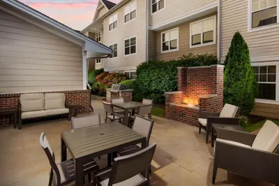 a patio with tables and chairs and a fire pit at Residence Inn Hartford Rocky Hill in Rocky Hill