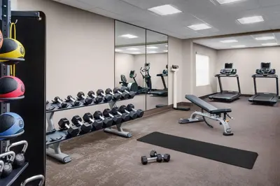 a gym with several tread machines and mirrors at Residence Inn Hartford Rocky Hill in Rocky Hill