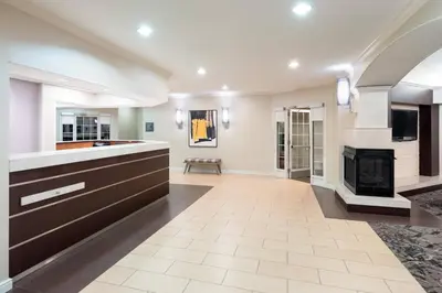 a large living room with a fireplace and a kitchen at Residence Inn Southington in Southington