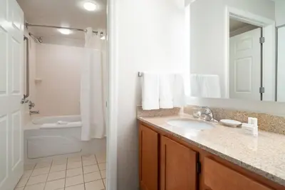 a bathroom with a sink and a shower and a tub at Residence Inn Southington in Southington