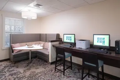 an office with a desk with two monitors and a couch at Residence Inn Southington in Southington