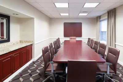 a conference room with a wooden table and chairs at Residence Inn Southington in Southington