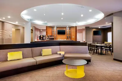 a living room with a couch and a table at SpringHill Suites Hartford Airport/Windsor Locks in Windsor Locks