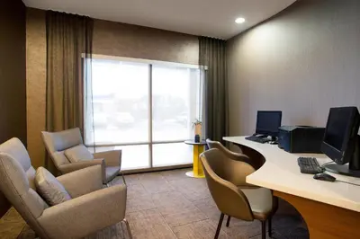 an office with chairs and a desk with a computer at SpringHill Suites Hartford Airport/Windsor Locks in Windsor Locks