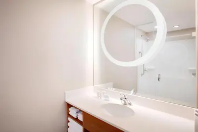 a bathroom with a sink and a mirror at SpringHill Suites Hartford Airport/Windsor Locks in Windsor Locks