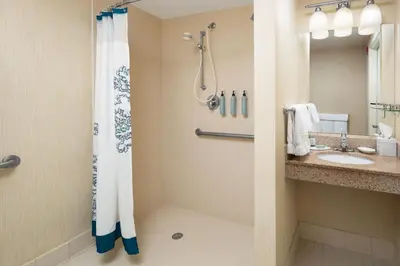 a bathroom with a shower and a sink at Residence Inn Milford in Milford