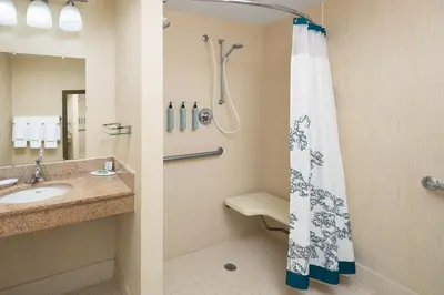 a bathroom with a shower and a sink at Residence Inn Milford in Milford