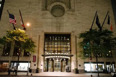 a building with an american flag in front of it at Four Seasons Hotel New York in New York