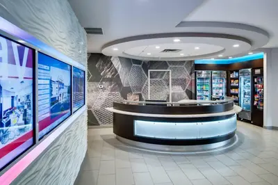 a store lobby with a waiting room with a round counter at SpringHill Suites Milford in Milford