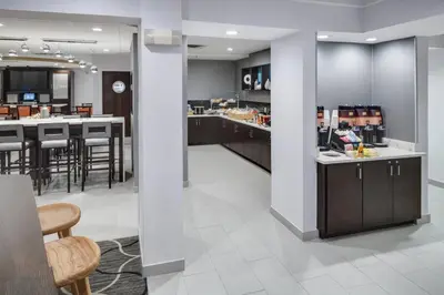 a kitchen and dining room with a counter and a bar at SpringHill Suites Milford in Milford