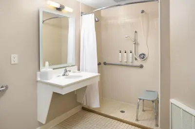 a bathroom with a sink and a shower at SpringHill Suites Milford in Milford