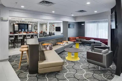 a lobby with a bar and a waiting room at SpringHill Suites Milford in Milford