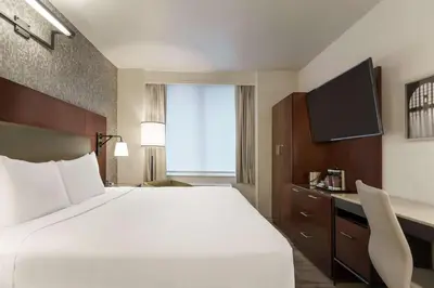 a hotel room with a large bed and a television at DoubleTree by Hilton New York Downtown in New York