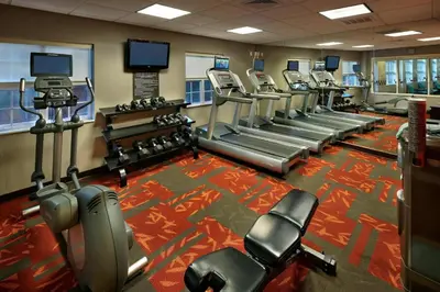 a gym with a row of treadmills and machines at Residence Inn Danbury in Danbury