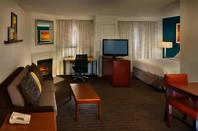 a hotel room with a bed and a fireplace at Residence Inn Danbury in Danbury