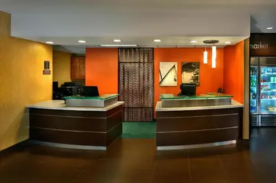 a lobby of a hotel with orange walls at Residence Inn Danbury in Danbury