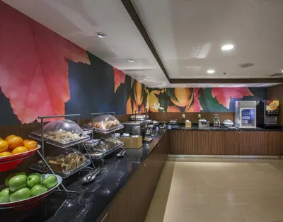 a buffet line in a restaurant with food at Fairfield Inn by Marriott East Rutherford Meadowlands in East Rutherford
