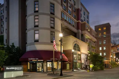 a tall building with an american flag in front of it at Residence Inn New Rochelle in New Rochelle
