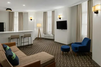 a hotel room with a couch and a tv at Residence Inn New Rochelle in New Rochelle