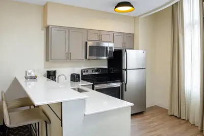 a kitchen with a refrigerator and a counter top at Residence Inn New Rochelle in New Rochelle