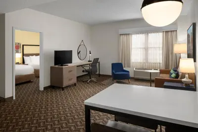 a hotel room with a bed and a living room at Residence Inn New Rochelle in New Rochelle