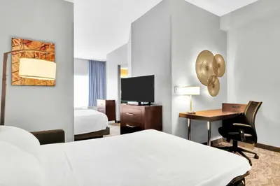 a hotel room with a bed and a desk at SpringHill Suites by Marriott Tarrytown Westchester County in Tarrytown