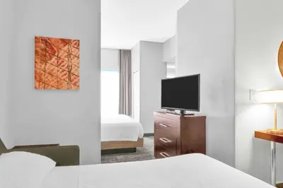 a hotel room with a bed and a flat screen tv at SpringHill Suites by Marriott Tarrytown Westchester County in Tarrytown