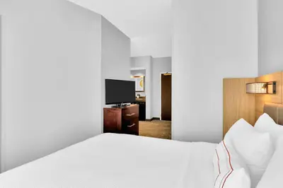 a hotel room with a bed and a television at SpringHill Suites by Marriott Tarrytown Westchester County in Tarrytown